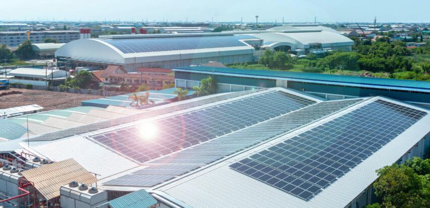 Solar panels on the roof of a building, sun shining on them